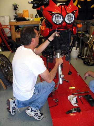 Rich installing Sonic Springs on a buddy's Triumph Tiger